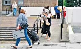  ??  ?? Residents leave Dorney Tower. Below: Georgia Gould of Camden council and a Chalcots Estate tenant