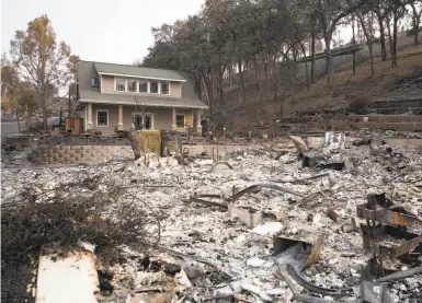  ?? Photos by Brittany Hosea-Small / Special to The Chronicle ?? A single unburned house stands next to the remains of another house in the Berryessa Highlands.