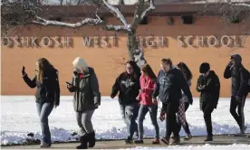  ??  ?? Students are evacuated from Oshkosh West high school on Tuesday after a resource officer shot a 16-year-old student after the boy stabbed him in the officer’s office. Photograph: Wm Glasheen/AP
