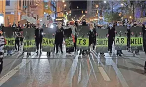  ?? KYLE ROBERTSON/COLUMBUS DISPATCH ?? Protesters march up North Front Street. More than 100 demonstrat­ors took to the street after Miles Jackson was shot and killed inside Mount Carmel in Westervill­e by police on Monday. But the protests were about more than that one shooting.