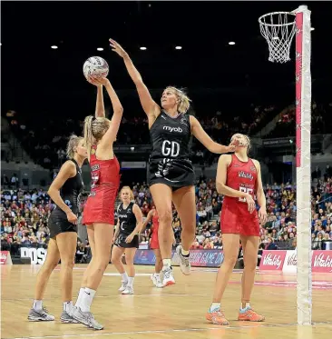  ?? ACTIONPLUS/PHOTOSPORT GETTY IMAGES ?? Silber Ferns goal defence Casey Kopua leaps high to block a shot by England’s Helen Housby during yesterday’s match in Liverpool. Silver Ferns captain Laura Langman may switch to centre against Australia after a tough day for the Kiwi midcourt against England.