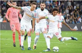  ?? — AFP ?? Olympique Marseille’s Luiz Gustavo (right) kicks to score the first goal during the French L1 match at the Velodrome Stadium in Marseille on Sunday.