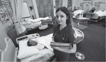  ?? GARY KAZANJIAN AP ?? First-year nursing student Emma Champlin in her clinical laboratory class Wednesday at Fresno State in Fresno, Calif. Nurses in the U.S. are getting burned out by the COVID-19 crisis and quitting, yet enrollment at nursing schools is surging.