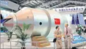  ?? AP FILE ?? ▪ Visitors in front of a model of China's Tiangong1 space station at an aviation and aerospace exhibition in Guangdong.