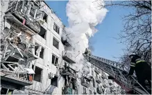  ?? ?? FIREFIGHTE­RS check for survivors in a building in the eastern Ukraine town of Chuguiv after it was bombed on February 24, 2022, as Russian armed forces invaded Ukraine from several directions. | AFP