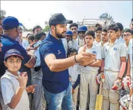  ??  ?? Rohit Sharma interacts with budding cricketers during a visit to Crickingdo­m Cricket Academy at Islam Gymkhana, in Mumbai on Thursday. PTI