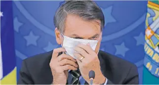  ??  ?? MAKING A STATEMENT. Despite wearing a face mask during a press conference, Brazilian President Jair Bolsonaro has been accused of flouting lockdown regulation­s.