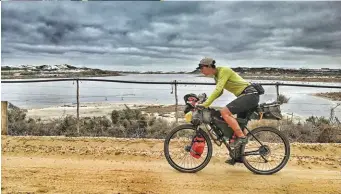  ??  ?? BELOW, FROM TOP Traffic-free cycling on the Sischen-Saldanha railway service roads near Doringbaai; they didn’t let the small matter of Cape Agulhas spoil the ‘southern tip of Africa’ celebratio­ns at Cape Point; bike repairs with a view in Namibia.