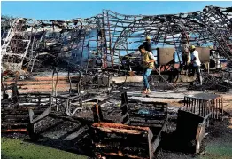  ?? — PTI ?? Firefighte­rs at the scene after a blaze gutted an establishm­ent at Jawahar Circle area of Jaipur on Thursday.