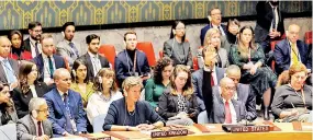  ?? ?? US Deputy Ambassador to the UN Robert Wood (2nd R) raises his hand during a UN Security Council after the vote about a ceasefire in Gaza at UN headquarte­rs in New York on Dec 8. (AFP)