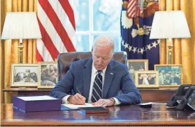  ?? AFP VIA GETTY IMAGES ?? President Joe Biden signs the American Rescue Plan in 2021.