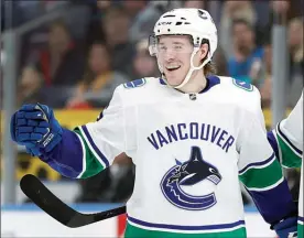  ?? The Associated Press ?? Canucks forward Brock Boeser celebrates after scoring a hat trick during the third period of a 6-1 win Sunday against the St. Louis Blues.