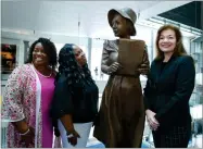  ?? AP PHOTO BY JOSE LUIS MAGANA ?? From left, Penny Allison Lockhart and Angela Alice Stephens, great nieces of Alice Allison Dunnigan, stand with sculpture artist Amanda Matthews during the unveiling of Dunnigan’s statue at the Newseum, Friday, Sept. 21, in Washington.