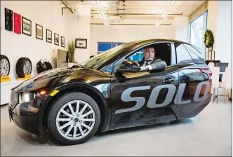  ?? DARRYL DYCK/BLOOMBERG ?? Jerry Kroll, founder and chief executive officer of Electra Meccanica Vehicles Corp., sits inside a Solo electric vehicle in Vancouver, British Columbia.