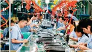  ?? Photo: Xinhua ?? Workers make electric heaters in Foshan, Guangdong. Industrial output is expected to have mildly recovered in the third quarter.