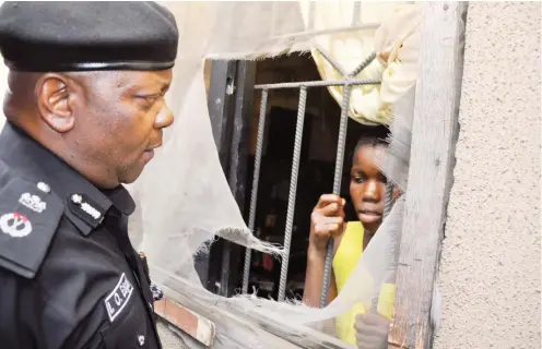  ?? Photo: NPF ?? A teenager (Miss Precious Nwafor) who was detained in an apartment at No.12 Baderin Street, Mafoluku -Oshodi for one week by her aunt chats with the Lagos State Police Commission­er, Edgal Imohimi, who ordered that the door be forced open and handed her...