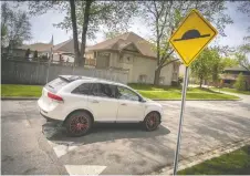  ?? DAX MELMER ?? A vehicle drives over a speed bump on Bartlet Drive in South Windsor last Thursday.