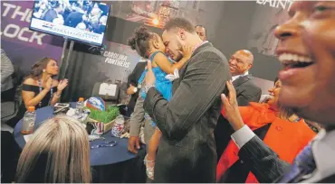  ?? | AP ?? Mike Evans of Texas A&M holds his 2-year-old daughter, Mackenzie, moments after he was picked in the first round by the Bucs.