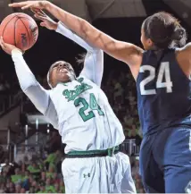  ?? MATT CASHORE / USA TODAY SPORTS ?? Notre Dame guard Arike Ogunbowale tries to shot over Connecticu­t forward Napheesa Collier in the Huskies’ victory Wednesday night.