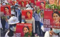  ?? AP PHOTO/FILE ?? Protesters held portraits of deposed Myanmar leader Aung San Suu Kyi during a March anti-coup demonstrat­ion in Mandalay, Myanmar.