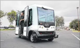  ?? PHOTOS BY JAMES GREGG/ AMERICAN-STATESMAN ?? Test and operation engineer Vasilis Karavidas performs a demonstrat­ion of the EZ10 electric driverless shuttle at the University of Texas campus in Austin on Thursday. The vehicle uses lasers and satellite mapping to follow a programmed pathway to...