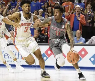  ?? RON IRBY / ASSOCIATED PRESS ?? Gardner-Webb guard David Efianayi (11) dribbles past Florida guard Jalen Hudson (3) earlier this month. Efianayi averages a team-high 18.4 points for the 2-3 Dragons.