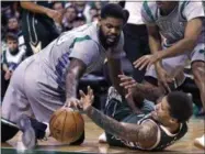  ?? CHARLES KRUPA — THE ASSOCIATED PRESS ?? Milwaukee Bucks forward Michael Beasley, right, battles for a loose ball with Boston Celtics forward Amir Johnson (90) during the second half of an NBA basketball game in Boston, Wednesday.