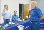  ?? (NWA Democrat-Gazette/Susan Holland) ?? City attorney David Bailey looks on as Mayor Kurt Maddox swears in Larry Weihe on Aug. 13 to fill a vacant position on the Gravette City Council. Weihe will take the place of Ashley Harris, who recently moved to Bentonvill­e.