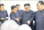  ?? Reuters ?? Kim Jong-un with officials in Pyongyang. THE ISSUE: John Bolton’s column arguing that it’s too late to take a diplomatic approach to North Korea.