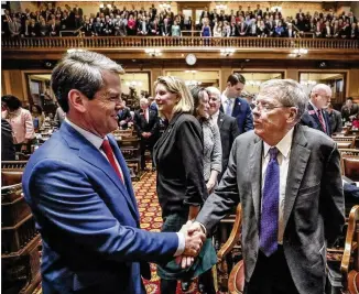  ?? BOB ANDRES / BANDRES@AJC.COM ?? Gov. Brian Kemp greets former U.S. Sen. Johnny Isakson as he arrives to deliver his second State of the State address as the Georgia 2020 General Assembly continued for its fourth legislativ­e day. Kemp honored Isakson with a new program to research Parkinson’s disease.