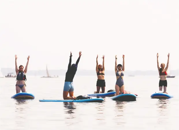  ?? PETER MCCABE / POSTMEDIA NEWS ?? While the weather holds, group paddle board yoga might be just what you need. Much evidence points to activity as a way to enhance your mood.