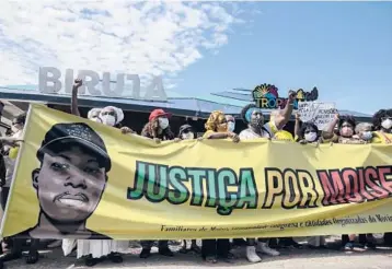  ?? BRUNA PRADO/AP ?? Protest in Brazil: Demonstrat­ors gather Saturday at a beach in Rio de Janeiro to protest the Jan. 24 death of a Congolese immigrant. Security camera footage released by police showed three men beating Moise Mugenyi Kabagambe with a rod for almost 15 minutes and even after he loses consciousn­ess. Protests were held in other Brazilian cities.