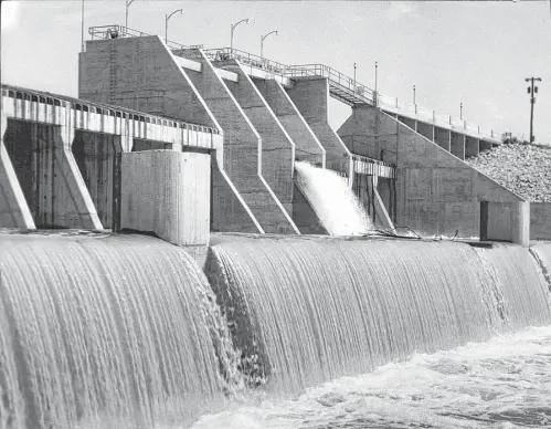  ?? Houston Chronicle fie ?? Water pours over San Jacinto Dam out of Lake Houston. Completed in 1955 on the San Jacinto River, the lake at capacity is 12,500 acres big and holds 52 billion gallons of water. The lake has developed into a playground as well as a reservoir for the...