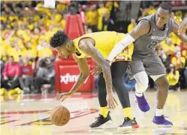  ?? NICK WASS/ASSOCIATED PRESS ?? Northweste­rn guard Scottie Lindsey, right, fights for the ball against Maryland guard Dion Wiley during the Terps’ win Saturday. Wiley finished with 10 points in 26 minutes.