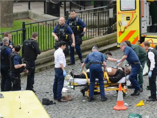  ??  ?? Paramedics attend to the man believed to be the suspect in the attack (PA)