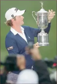  ?? AP Photo by ERIC RISBERG ?? Webb Simpson poses with the championsh­ip trophy after the U. S. Open Championsh­ip golf tournament Sunday at The Olympic Club in San Francisco.