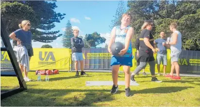  ?? Photo / Sandra Conchie ?? Aucklander Toni Jacka (far left) watches her son Max, 8, lift a 20kg dumbbell at the Ultimate Athlete Demo Day at Mount Drury.