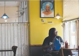  ??  ?? Erica Daniel of Aurora has lunch at Welton Street Cafe. “One of the biggest challenges of that era for soul food restaurant­s, or just AfricanAme­rican restaurant­s, is the neighborho­od joint becomes a destinatio­n restaurant,” said Adrian Miller.