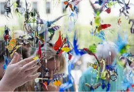  ?? Emily Matthews/Post-Gazette ?? Shoppers check out glass figurines made by Thomas Von Koch, of Toughkenam­on, at last year’s Dollar Bank Three Rivers Arts Festival, Downtown. This year’s edition will take place June 3-12.