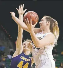  ?? The Associated Press ?? Northern Colorado’s Bridget Hintz tries to stop Michigan’s Hallie Thome from scoring during Friday’s game in Waco, Texas. Thome contribute­d 24 points to the Wolverines’ 75-61 victory, ending the Bears’ season at 26-7.