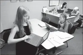  ?? NWA Democrat-Gazette/DAVID GOTTSCHALK ?? Kali Daniels (left), a fourth-grader at Fayettevil­le Virtual Academy, arrives Tuesday in Melissa Green’s fourth- and fifth-grade class at the school in Fayettevil­le. The school continues to expand in its second year and has added grades nine through 12 and added six educators this year.