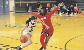  ??  ?? YUMA HIGH’S BELINDA GRADIAS of Saturday’s game. (0) tries to dribble by Dysart’s Badawia Eisa in the third quarter