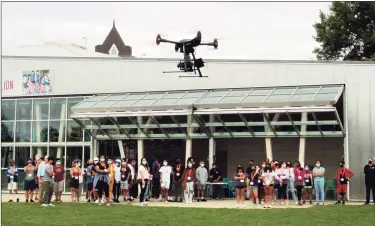  ?? Christian Abraham / Hearst Connecticu­t Media ?? A group of 50 incoming high school freshman in Stamford High School, who've started working towards a technology-focused college degree through the Beyond Limits Summer Scholars Program, attend an unmanned aerial vehicle (UAV) flight demonstrat­ion by Aquiline Drones at Mill River Park in Stamford on Thursday.