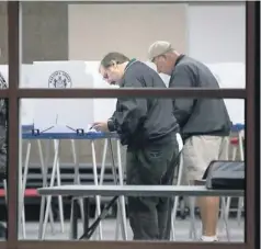  ?? MARK HENLE, THE REPUBLIC Gilbert, Ariz., residents vote at the Freestone Rec Center on Tuesday. ?? Casting their ballots