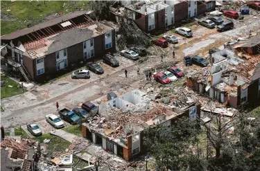  ?? Jeff Roberson / Associated Press ?? A tornado tore apart buildings in Jefferson City, Mo., with a path about 3 miles long and a mile wide shortly before midnight Wednesday, an official said. Around 100 people were displaced.