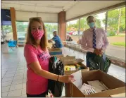  ?? ?? North Penn Educationa­l Foundation Executive Director Christine Liberaski, left, and Assistant Superinten­dent Todd Bauer hold backpacks filled with school supplies during the district Educationa­l Foundation’s third annual “Build-a-bag” drive in 2020.