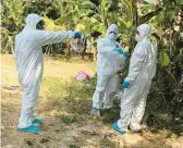  ?? CAMBODIA MINISTRY OF HEALTH ?? Health workers spray disinfecta­nt Friday in the Prey Veng province of Cambodia. A girl from the province died after contractin­g the bird flu virus.