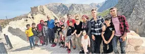  ?? ?? Appeal Ekrem Ozturk, middle in red, fears for his family’s safety, after many of them saw all of their possession­s and homes destroyed in the devastatin­g earthquake