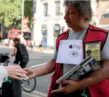  ?? GETTY IMAGES ?? In Britain, Apple Pay can be used to buy homeless charity magazine The Big Issue. In New Zealand it can be a struggle to buy a cup of coffee using the app.