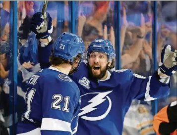  ?? O’MEARA/THE ASSOCIATED PRESS CHRIS ?? Tampa Bay Lightning center Brayden Point (21) celebrates with Nikita Kucherov after Point scored against the Boston Bruins during the second period of Game 5 of an NHL second-round playoff series Sunday in Tampa, Fla.
